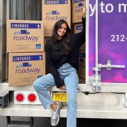 Famous fashion model Kelsey Merritt posing in front of Roadway Moving's truck during her move in NYC