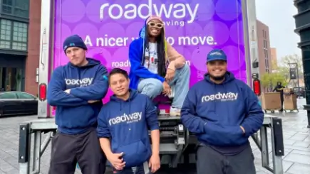 Roadway Moving's crew with a happy customer