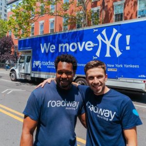 Roadway Moving's crew in front of Roadway's New York Yankees branded truck